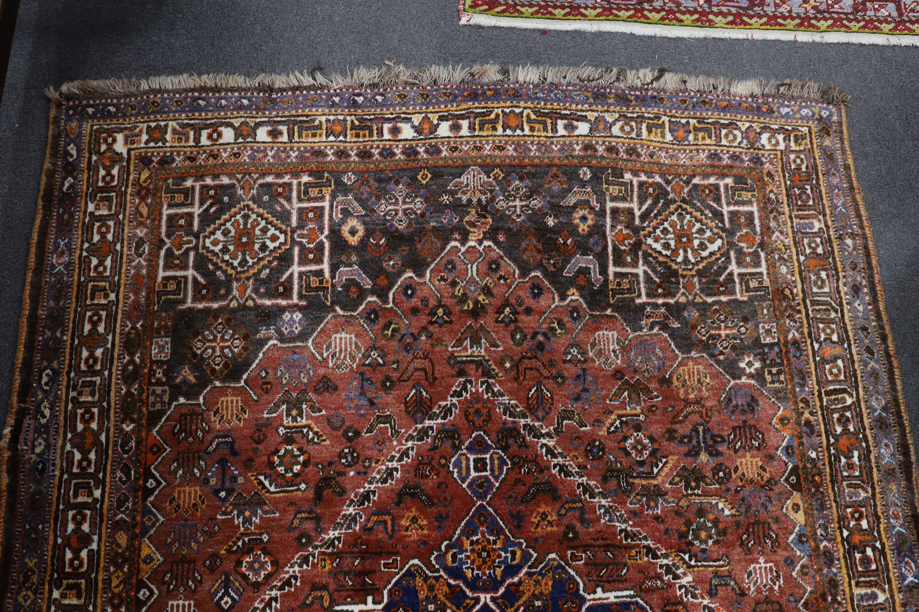 A North West Persian red ground rug, 214 x 156cm